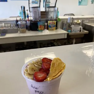 Acai bowl with mango, granola, banana chips, and strawberries