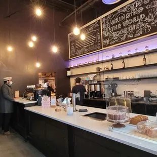 a coffee shop counter with coffee and pastries