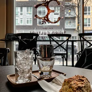 a glass of water and a plate of food on a table