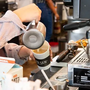 a bari serving a cup of coffee