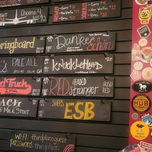 a wall of beer menus