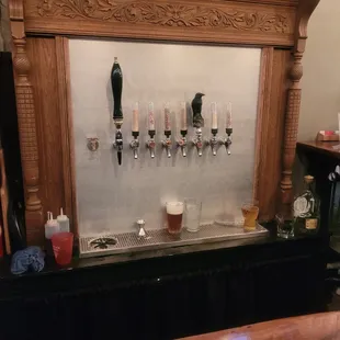 a row of beer taps on a bar