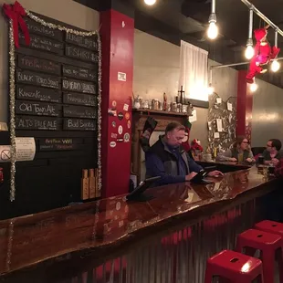 A quick shot of all the beers they have! Enjoy the refinished wood bar or the antique door tables!