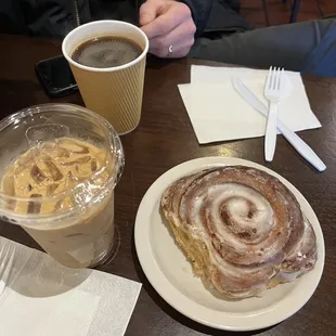 Cinnamon roll, iced latte, and an americano