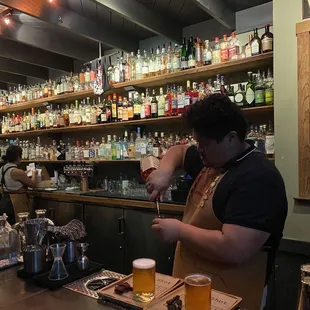 a bartender pouring a drink at a bar