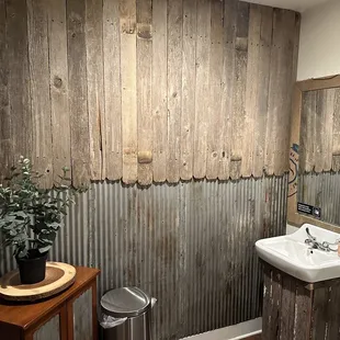 a rustic bathroom with corrugated walls
