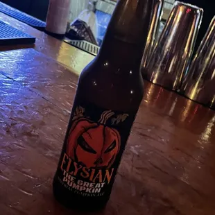 a bottle of beer on a bar counter