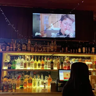a woman watching a television