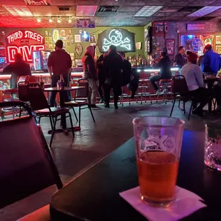 people in a bar with neon signs