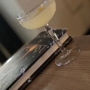 a glass of lemonade and a book