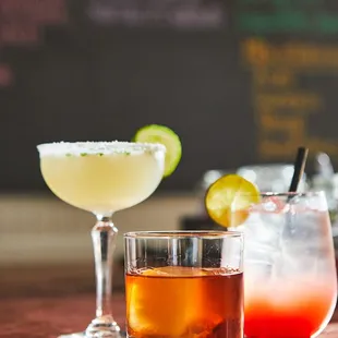 two cocktails on a bar