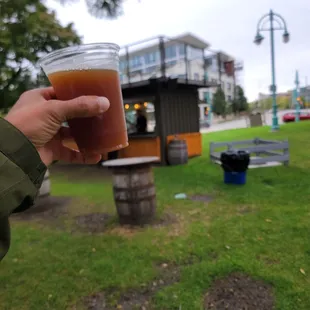 a person holding a glass of beer