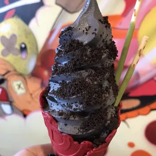 Vanilla charcoal soft serve with matcha pocky &amp; oreo crumb