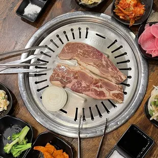 Marinated bone in short rib on the grill plus banchans