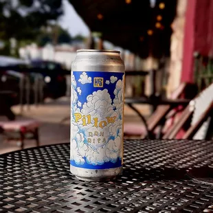 a can of beer sitting on a table