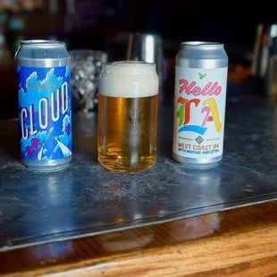 three cans of beer on a bar