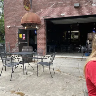 some outdoor seating in the back, looking in