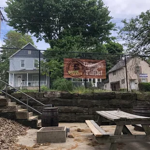 a picnic table in front of a brick wall