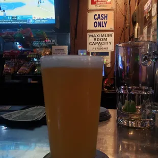 a pint of beer on a bar