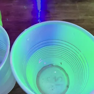 two plastic bowls on a wooden table