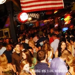 a crowd of people at a bar