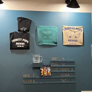 a wall with t - shirts on it
