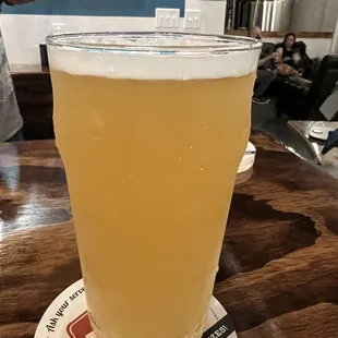 a pint of beer on a coaster