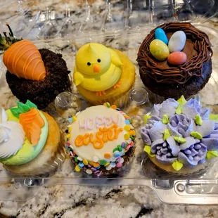 a variety of decorated cupcakes