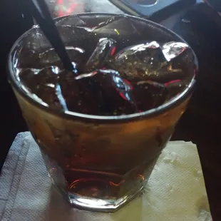 a drink in a glass with ice cubes