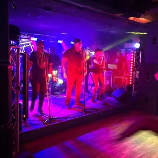 a group of men singing on stage