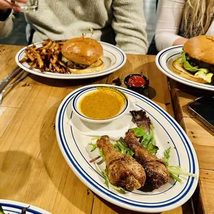 three plates of food on a wooden table