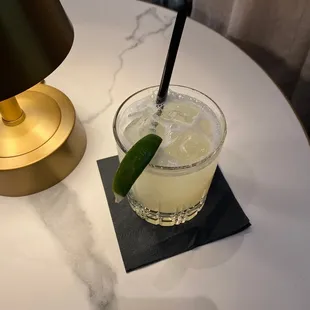 a glass of lemonade with a lime wedge