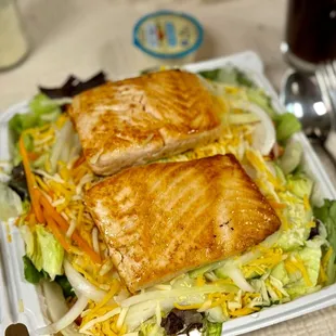 two pieces of fish on a salad