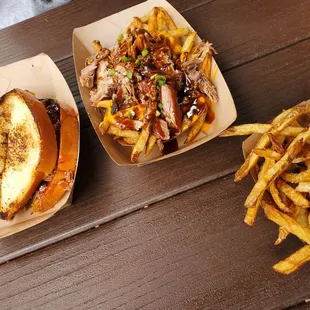 Brisket sandwich with fries and baked beans as the sides. Loaded fries with pulled pork.