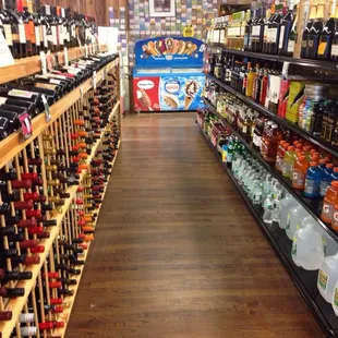 a wide aisle of wine bottles