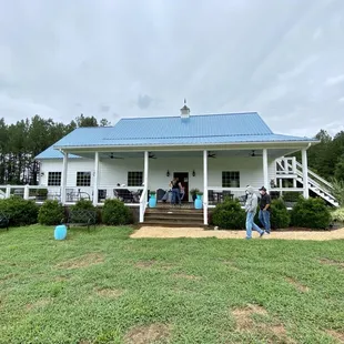 people walking in front of the house