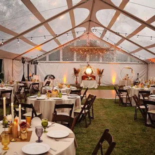 Outdoor wedding reception under a tent at Thistledome House.