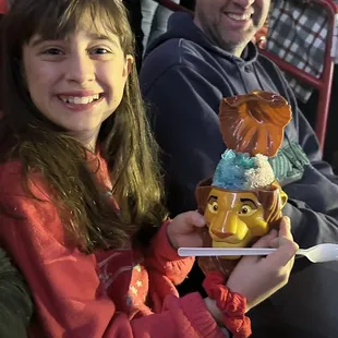 a young girl holding a cake