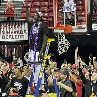 Arop (Aztecs' forward) cut down the net.