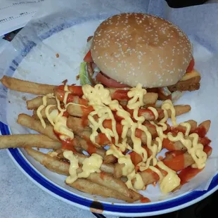 Chicken nuggets burger &amp; cheese fries with a little bit of hot sauce.