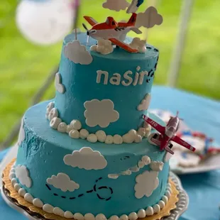 a blue cake with a plane on top