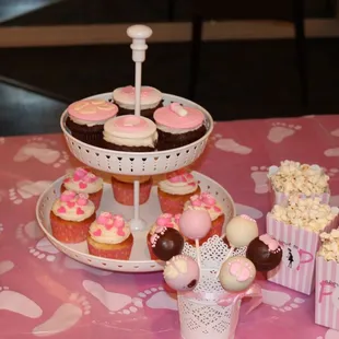 a display of cupcakes and cookies