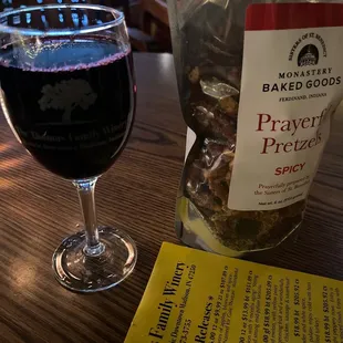 a glass of wine and a bag of pretzels