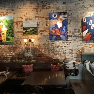 a brick wall with paintings on it