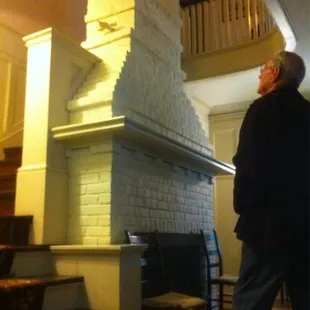 Two story fireplace surrounded by stairs