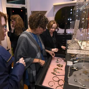 Customers shop Thomas Mann's jewelry collection at Gallery I/O.