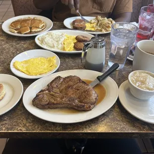 T one, scrambled eggs, grits, biscuit, and coffee