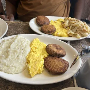 Grits, scrambled eggs, and salmon croquettes has browns with onion and peppers