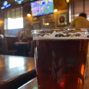 a pint of beer on a bar