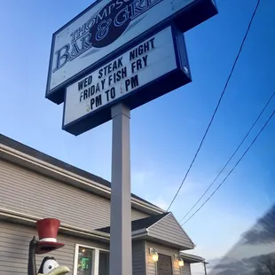 a penguin statue in front of a restaurant
